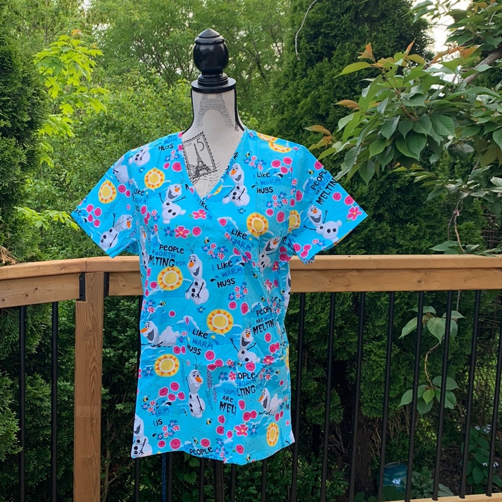 Disney Frozen Scrub, light aqua blue with flower/sun/Olaf prints. size M